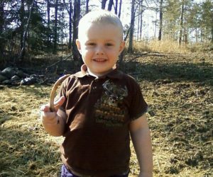 son-holding-antler-shed