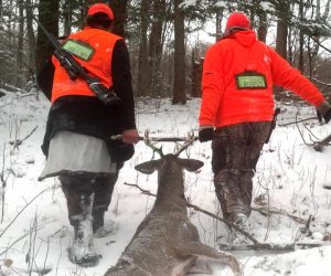 hunters-dragging-buck-out-of-woods