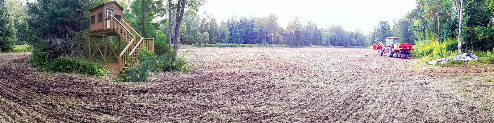 elevated-hunting-stand-with-deer-windows-surrounded-by-food-plot-planted-with-no-till-seeder